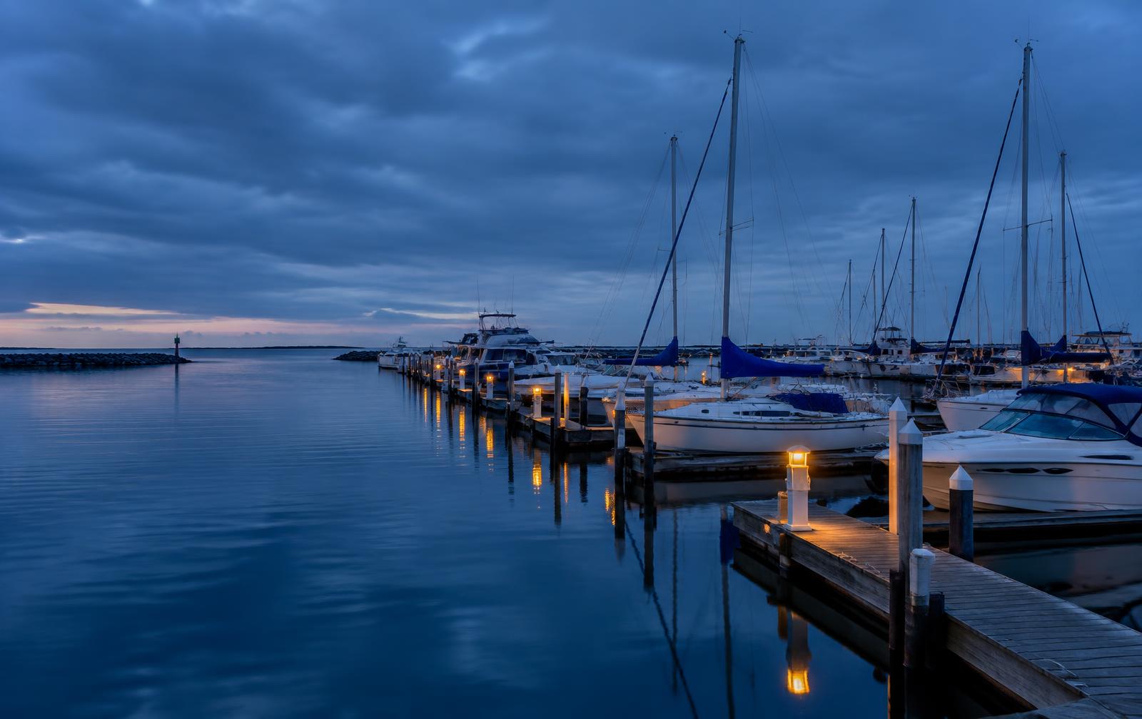 Boats at a marina dock at dusk